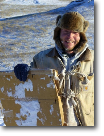 Happy sledder with homemade sled.